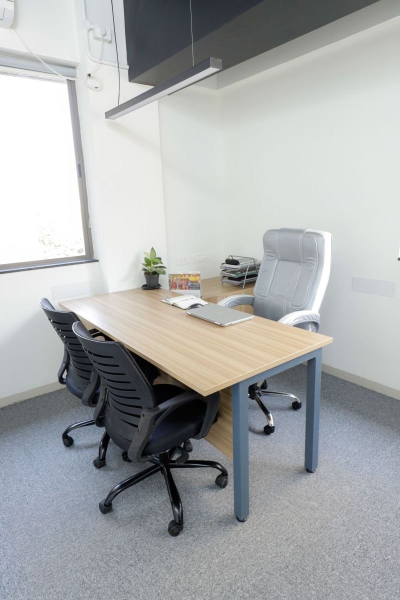 Private cabin with desk and chairs, managed office built by Workin Space