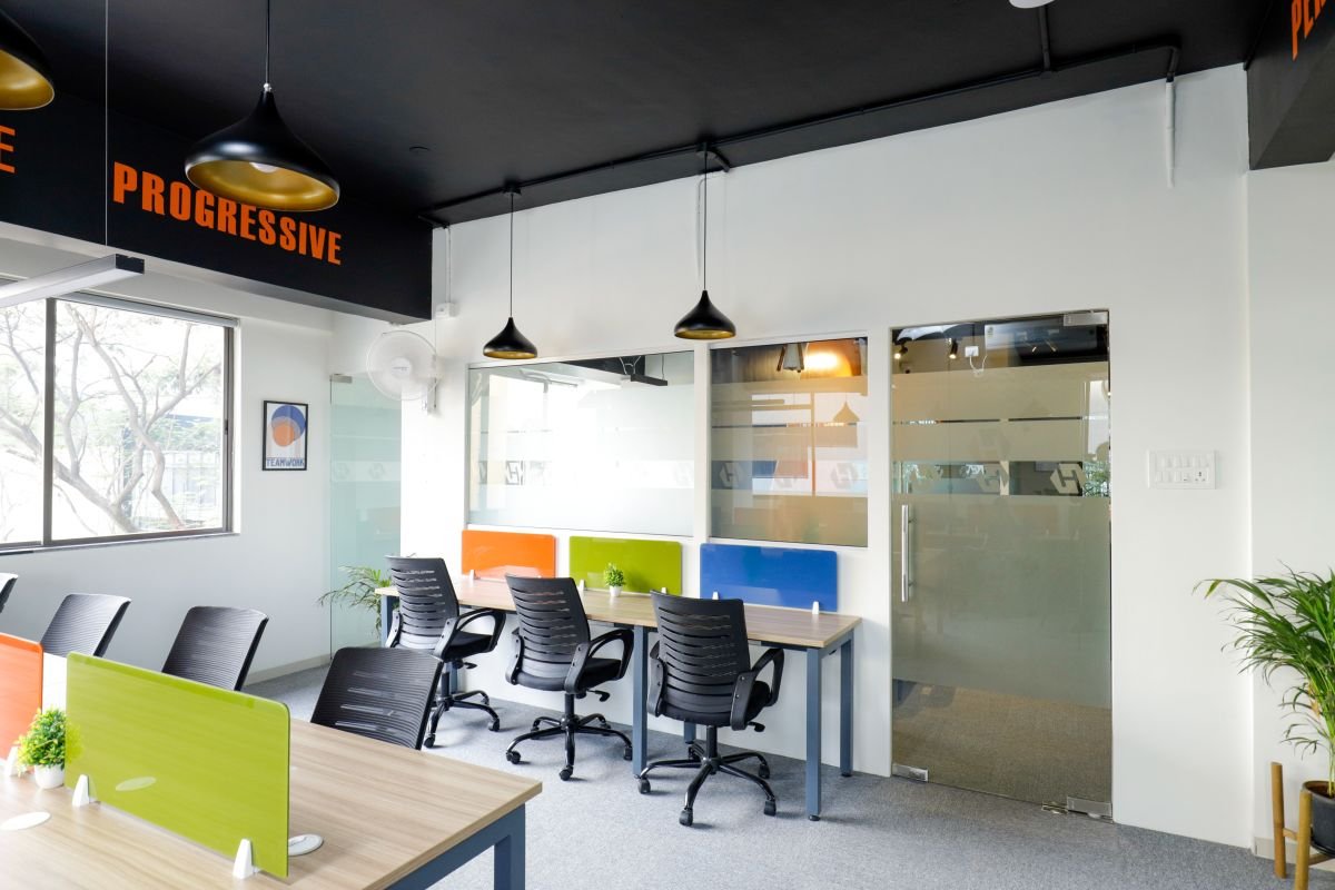 Open desks with coloured partitions, managed office built by Workin Space