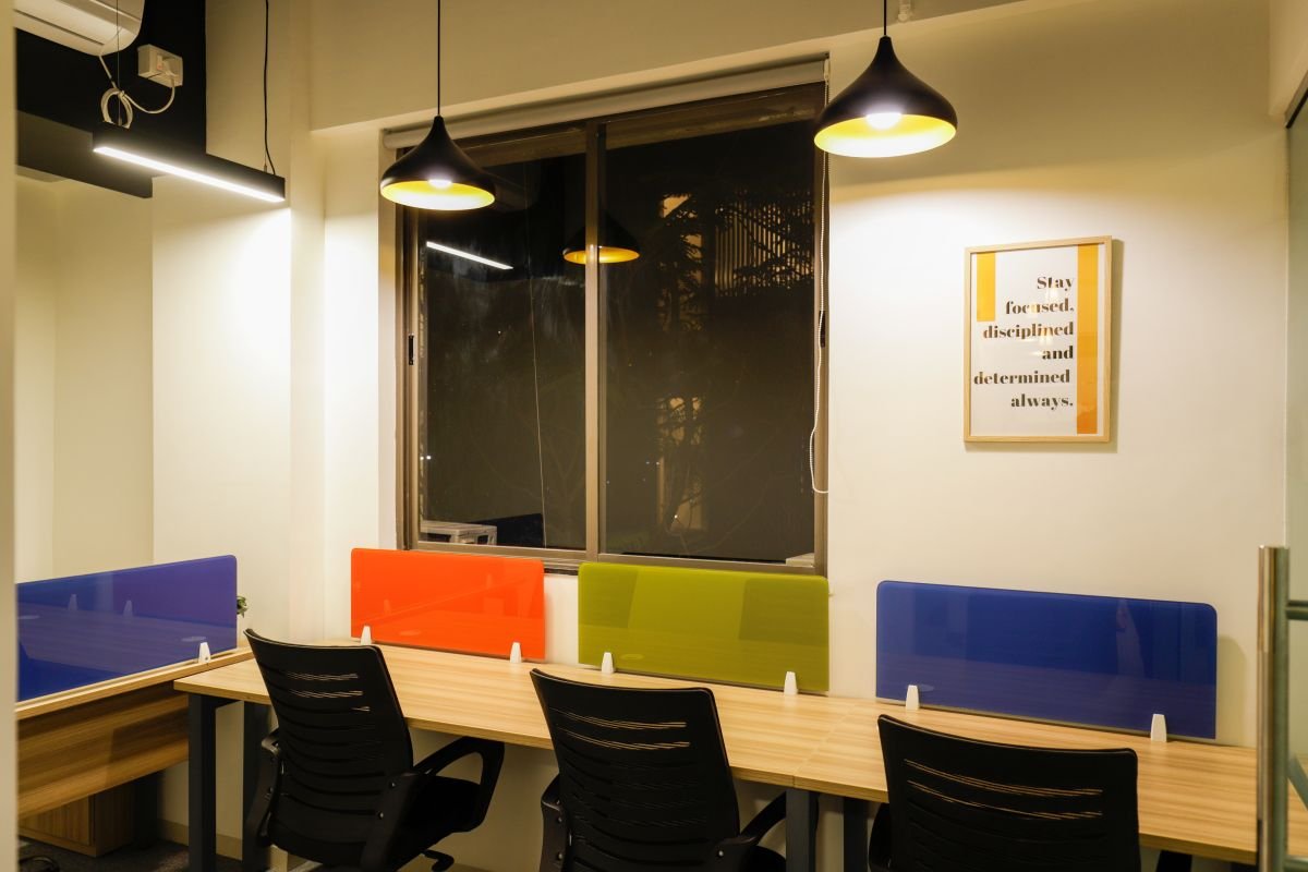 Team desks with coloured privacy panels, managed office built by Workin Space