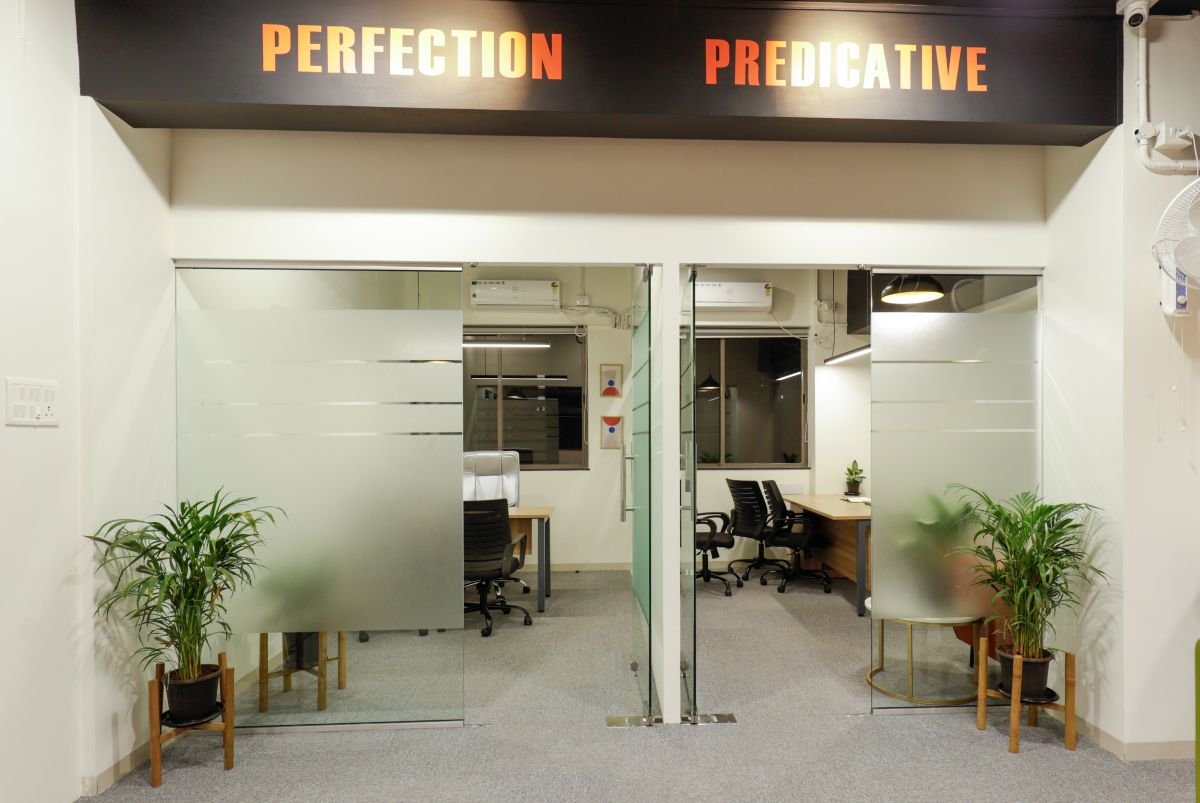 Glass cabin entrance with plants, managed office built by Workin Space